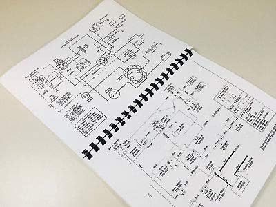 Open pages of the service manual showing a detailed diagram of a hydraulic system.
