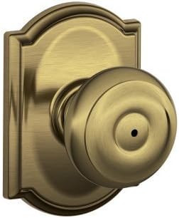 Schlage F40-GEO-CAM Privacy Georgian Door Knobset with the Decorative Camelot Ro, Antique Brass