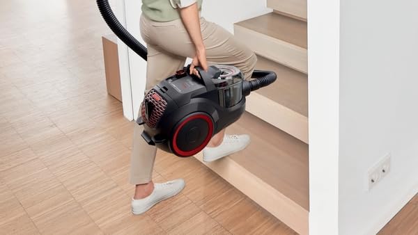 Person carrying the Bosch vacuum cleaner up a staircase