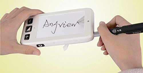Person using the Reizen magnifier with its writing stand extended, writing on a document