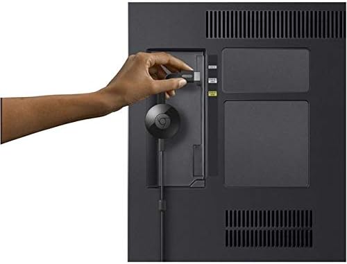 Hand plugging Google Chromecast into a TV's HDMI port