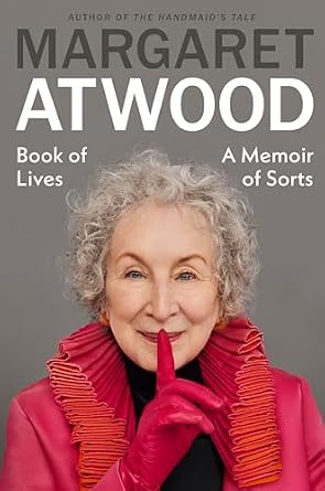 Memoir by Margaret Atwood with a picture of Atwood in a pink coat smiling with a pointer finger to her mouth.