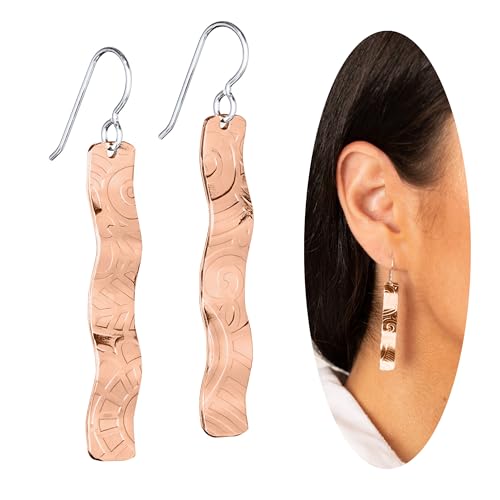 copper dangle earrings on a jewelry tray