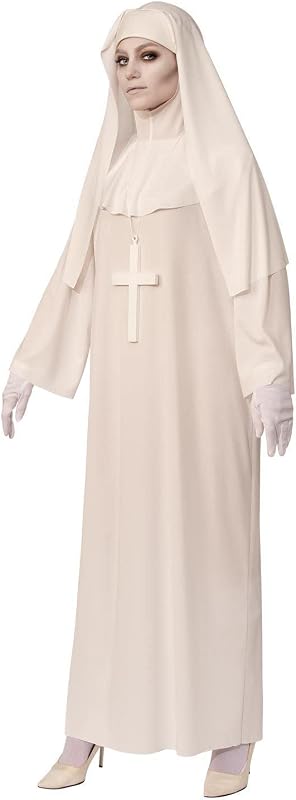 woman in a long white nun robe and veil with a large white cross, white gloves and pale makeup