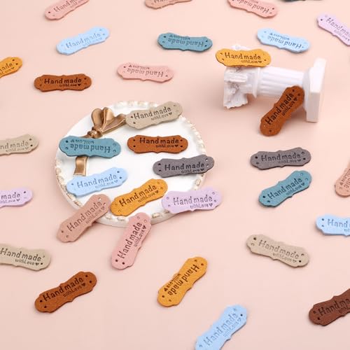 Image of SAVITA 50pcs Handmade Leather Labels, Microfiber Colorful Leather Labels with Love Hearts Handmade Embossed Crochet Tags with Holes for Crafts Knitting Sewing Hats Purses Clothing (10 Colors)