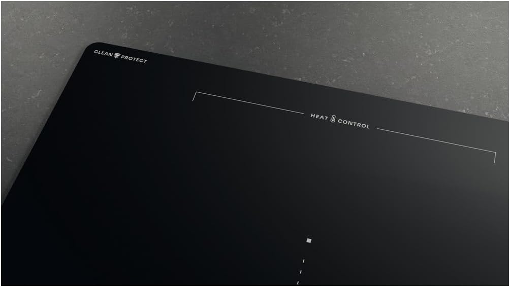 Close-up of the Whirlpool WEX9024DCFF2 induction hob surface, showing 'CLEAN PROTECT' and 'HEAT CONTROL' markings.