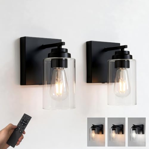 pair of matte black battery wall sconces mounted on a bedroom wall