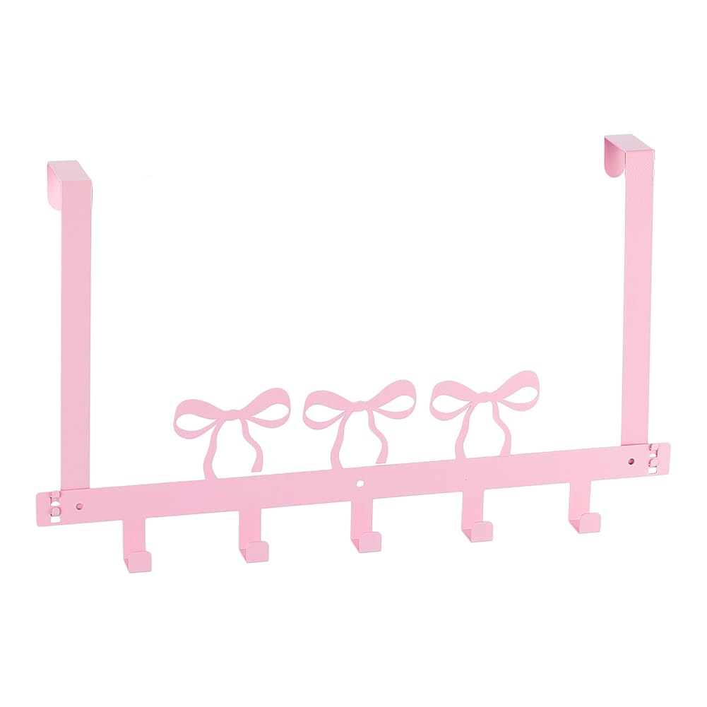 Crochets sur la porte roses pour suspendre vos serviettes de bain