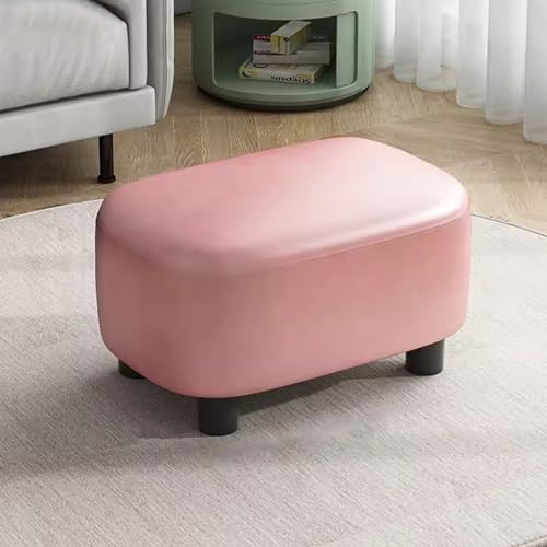 Repose-pieds en cuir rose près du canapé ou dans une entrée moderne
