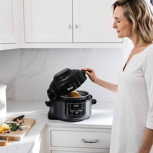 Woman closing the Ninja Foodi Crisping Lid