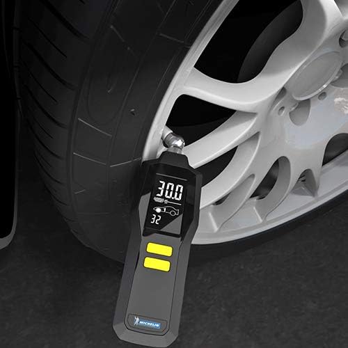 Michelin 12294A Tire Pressure Gauge in use on a car tire