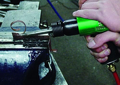 A person's hands holding the DYNAMIC POWER air hammer, actively chipping away at a metal surface, demonstrating its use.