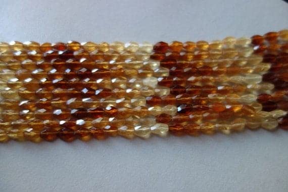 Gemmes hessonite multi facettées : perles ovales d'exception pour création de bijoux uniques