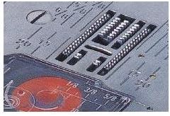 Close-up of the sewing machine's needle plate with various stitch patterns visible