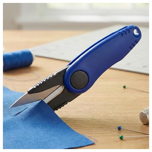 Folding fishing scissors for fishing line, compact blue fold-away cutting tool with safety lock, textured grip, fits tackle box pockets for rigging and leaders