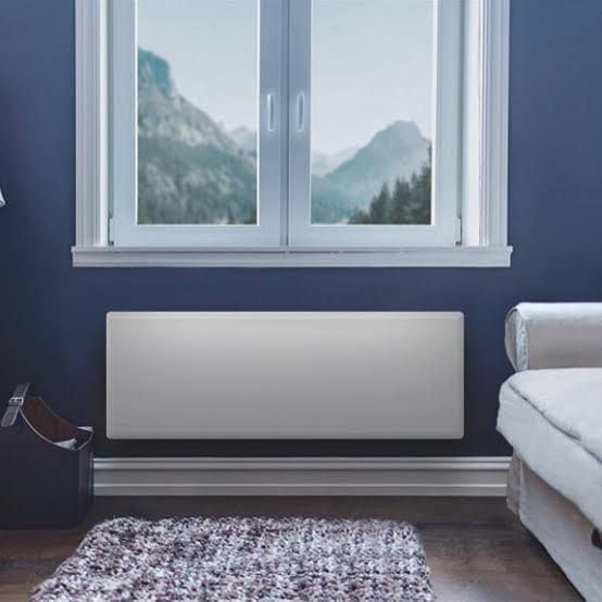 NOBO NTL4T 20 2000W Electric Heater mounted on a blue wall in a room with a window
