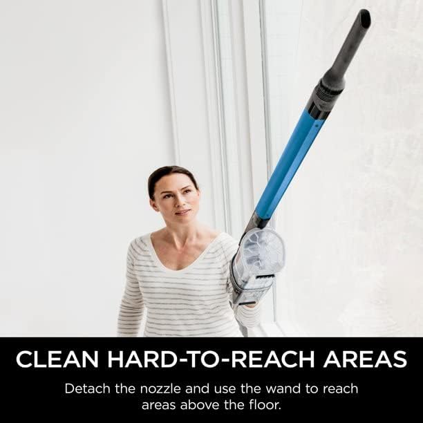 Woman vacuuming carpet with Shark IX140H
