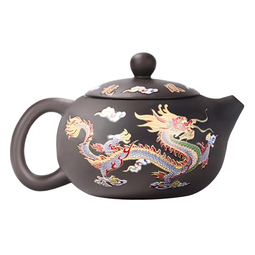 A small purple clay teapot with a dragon and phoenix design sitting on a tea tray