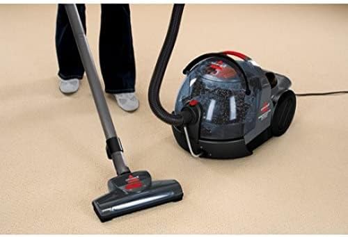 Person vacuuming a carpet with the BISSELL 81N7E