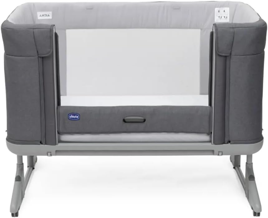 Chicco Next2Me Forever crib in co-sleeping mode with the side lowered, showing the mattress inside.