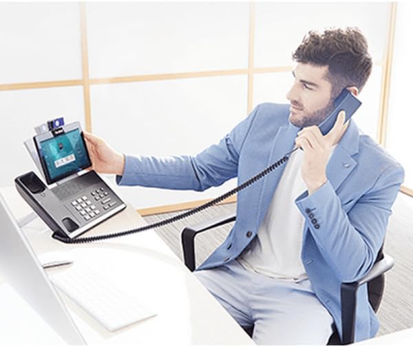 A person using the Cleyver T57W IP Phone and a headset in an office setting