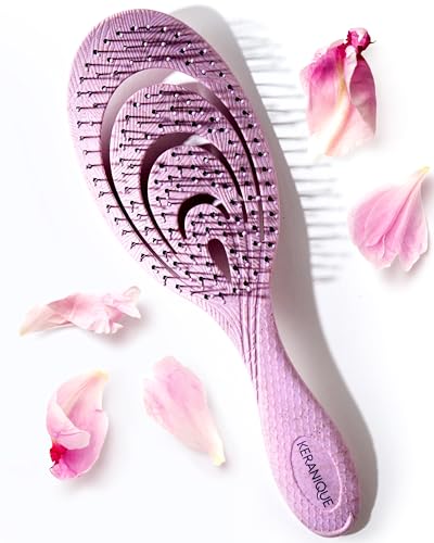 Keranique pink flexible paddle detangling brush with vented back — the heaviest pick at 4.66 oz