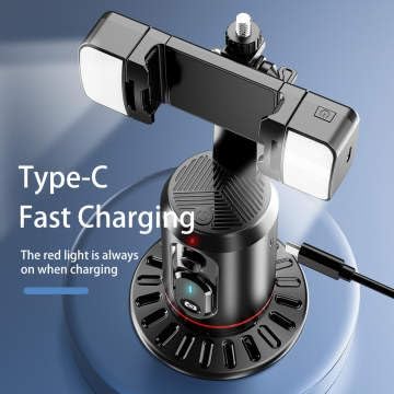 Close-up of the Q02 gimbal showing the Type-C charging port with a cable inserted. A red light is visible, indicating charging.