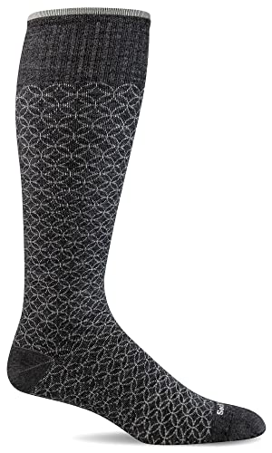 Black compression sock for travel, designed to improve circulation and reduce swelling during long flights.