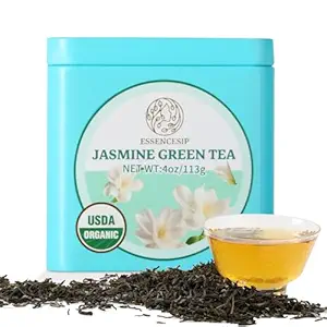 Reusable tin of loose jasmine Green Tea with loose tea spread out in front of the tin.