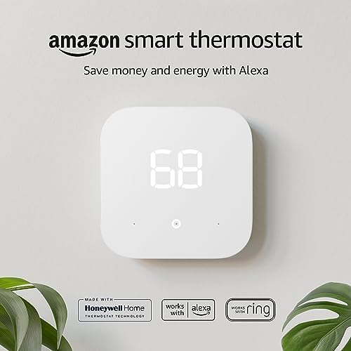 Amazon Smart Thermostat in white finish mounted on a US kitchen wall above a counter, the simple touch interface showing the current temperature in large legible numerals, an Echo Dot 5th generation visible on the counter below acting as a wireless remote temperature sensor — Alexa Hunches learning at a US$79.99 price point that many US utilities including ConEd and PG&E rebate by US$85-US$120.