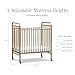 NAMESAKE Abigail 3-in-1 Portable Baby Crib with Wheels - GREENGUARD Gold Certified Convertible Crib to Toddler Bed & Daybed - Metal Baby Bed w/ 4 Adjustable Mattress Heights, for Small Spaces - Gold