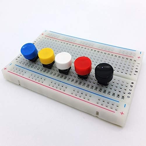 Multicolored push buttons inserted into a breadboard