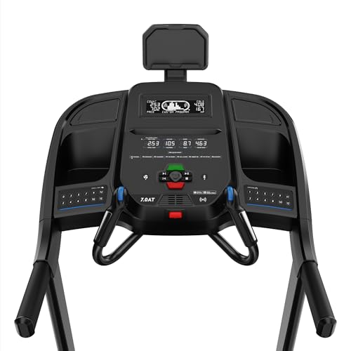 Close-up of Horizon Fitness 7.0 AT treadmill console with active LCD display showing speed 2.9 mph, incline, pulse 105, time 7:02, distance 0.8 mi, calories 46; QuickDial controls, numeric keys, Bluetooth icons, and tablet holder visible.