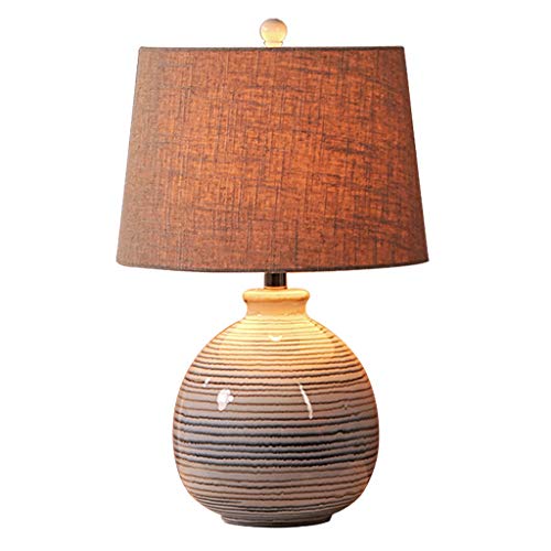 Lampe de chevet en céramique contre la fatigue oculaire sur table de nuit