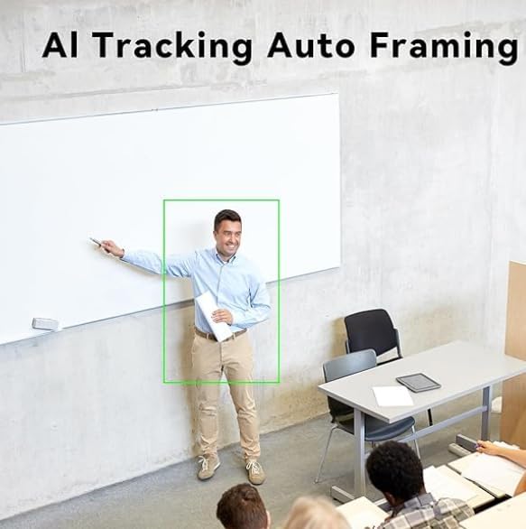 A person standing in front of a whiteboard, with a green rectangle indicating AI tracking and auto framing in action.
