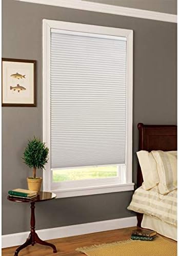 White blackout cordless cellular shade installed in a bedroom window