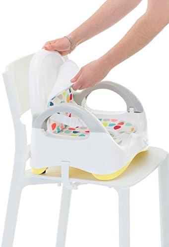 Hands demonstrating the folding mechanism of the Badabulle B009009 Booster Seat on an adult chair.