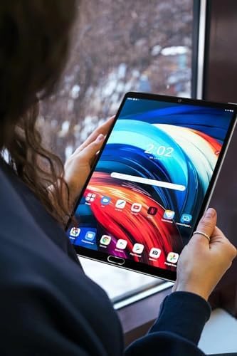 A person holding the GOODTEL G2 Tablet, displaying a colorful wallpaper on the screen.