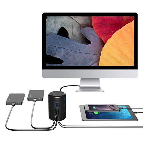 ORICO 4-Port USB 3.0 Cylinder Hub connected to a monitor, charging two tablets, and providing connectivity for other devices.