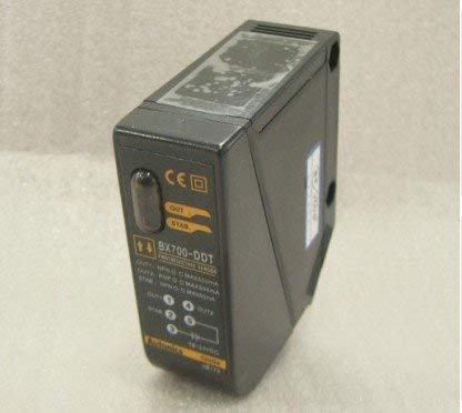 Close-up view of an Autonics BX700-DDT sensor showing labels for model number, output types, and wiring connections.