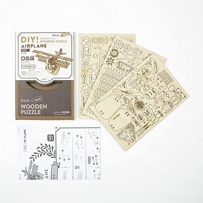 Contents of the 3D Wooden Puzzle kit, showing wooden sheets and instructions