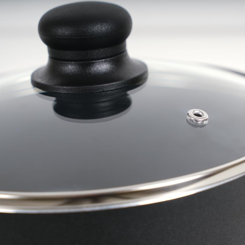 Close-up of a tempered glass lid with a black knob handle