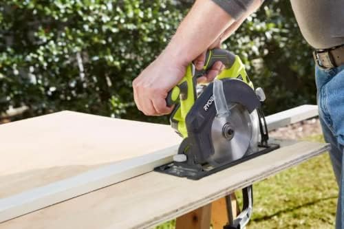 Close-up of a person using a circular saw to cut a wooden board