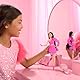 Barbie Deluxe Style-Puppe Nr. 2 mit Barbiecore-Outfit, schwarzen Haaren und glitzernder Beinprothese, pinkfarbenem Oberteil mit Stoffrose und passendem Rock sowie Accessoires, HYV26