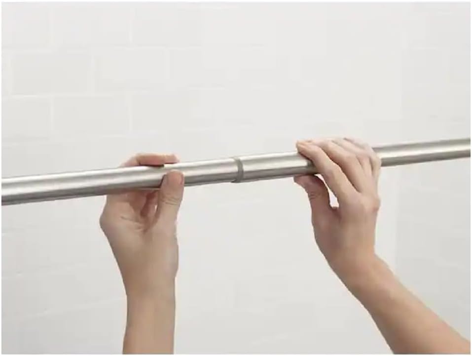 Hands adjusting the length of the Moen shower curtain rod