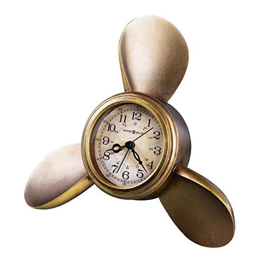 Howard Miller Propeller Alarm Table Clock 645-525 – Antique Brass Finish, Antique Parchment Dial, Arabic Numerals, Antique Home Décor, Quartz Movement