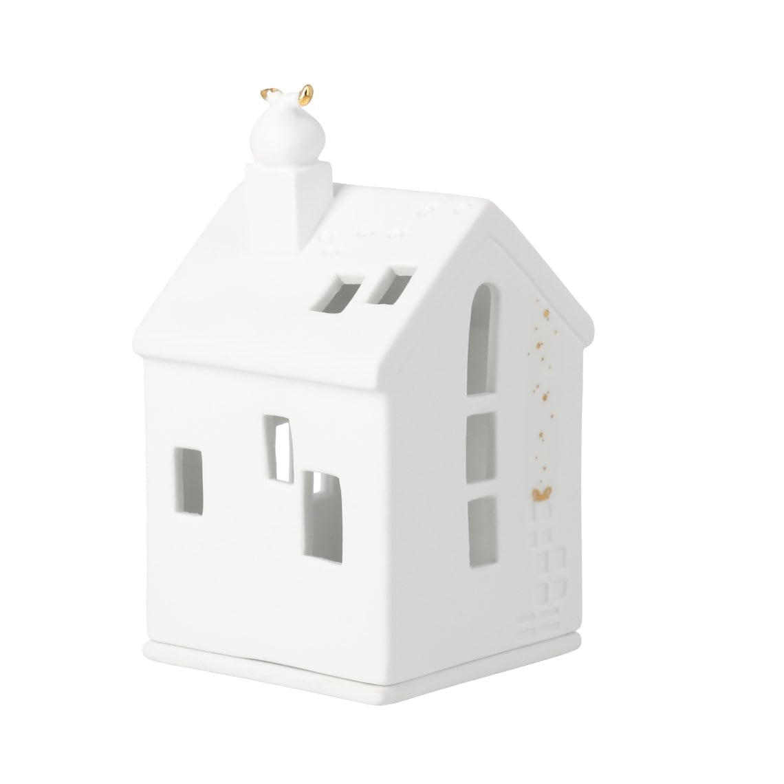 Maison de village en porcelaine sur une table de fête magique en hiver