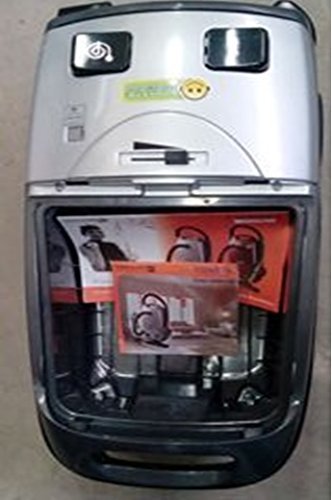 Ndani view of the vacuum cleaner's suction tank, showing where the user manual and demo CD are stored.