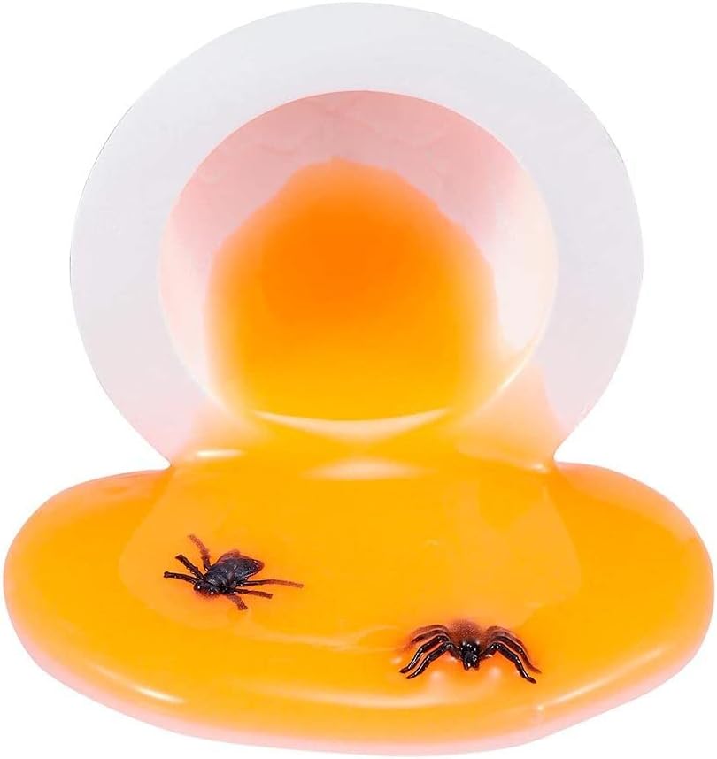 Orange slime with two small black spider figures inside, spilled from a white egg half.