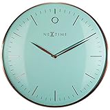 El reloj de pared glamor de nextime es muy elegante gracias a su frente de vidrio curvo y su marco de metal rosa dorado